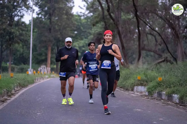 Two runners on a tree-lined road in Chandigarh during the race
