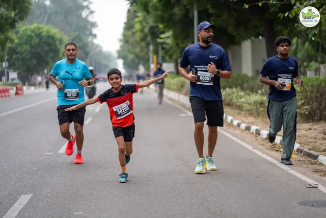 A man and a boy running side by side on the route