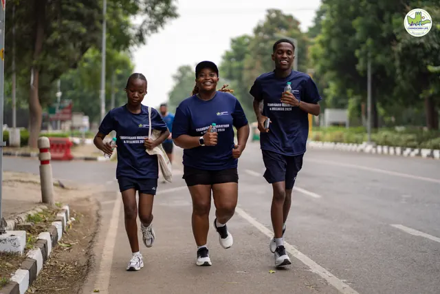 Three runners in event T-shirts on the road