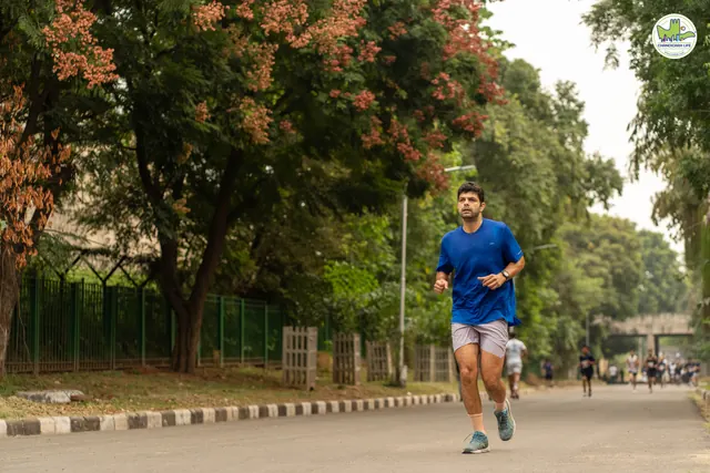 A man in blue running on the road