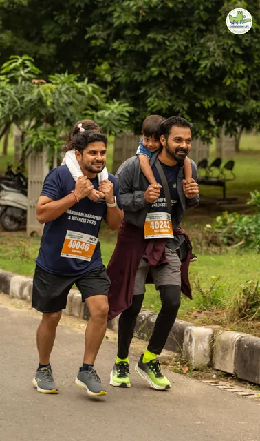 A runner carrying another man on his shoulders on the route