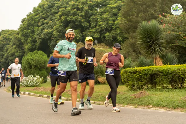 Three runners on the road, one in a light green T-shirt