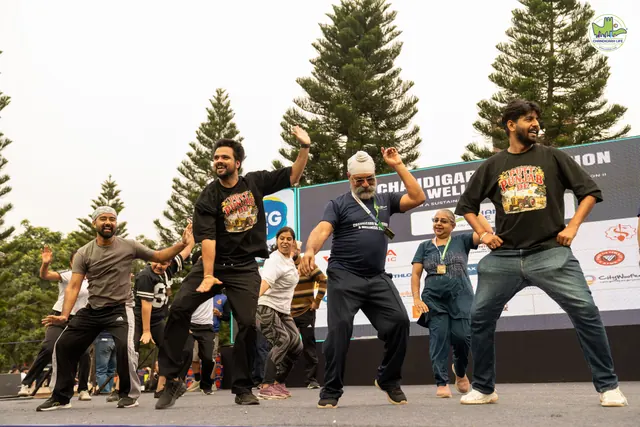 Participants mid-jump on the stage