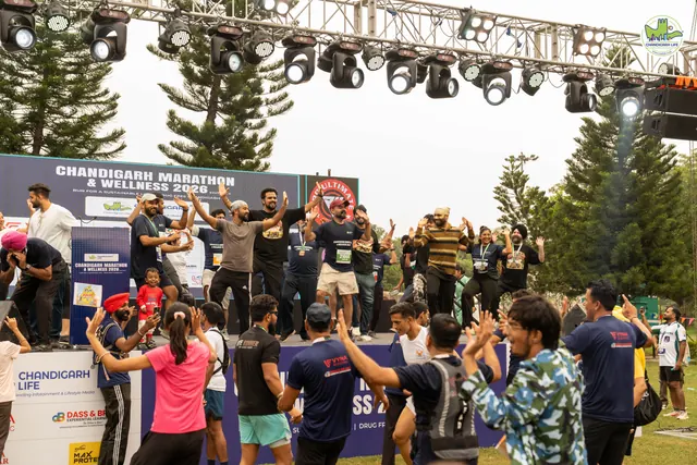 A crowd of participants dancing beside the stage