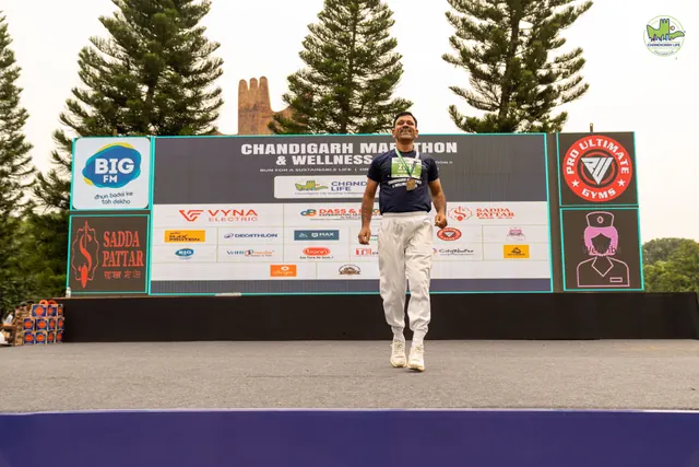 A speaker walking on the stage in front of the backdrop