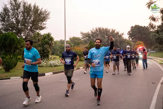 Runners on the road, one in a light blue T-shirt