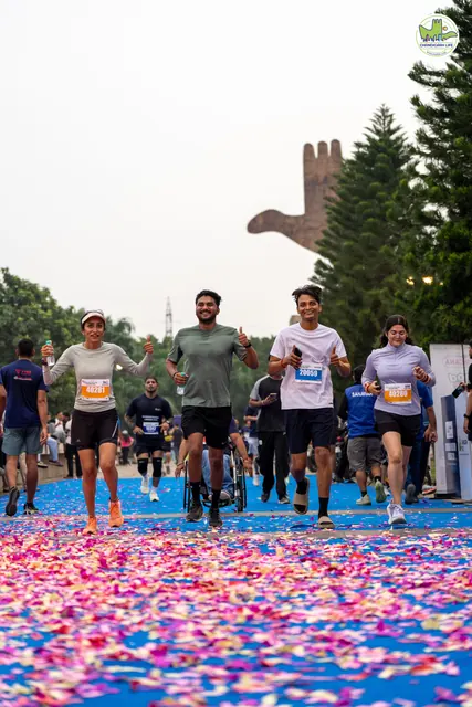 Runners crossing the petal-covered finish carpet