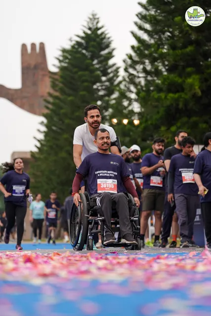 A wheelchair user finishing with a group of runners