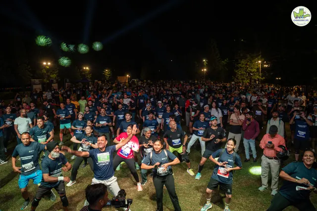 A crowd dancing in front of the stage at night