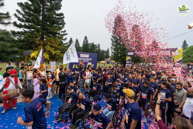 The flag-off seen from above, with confetti over the crowd
