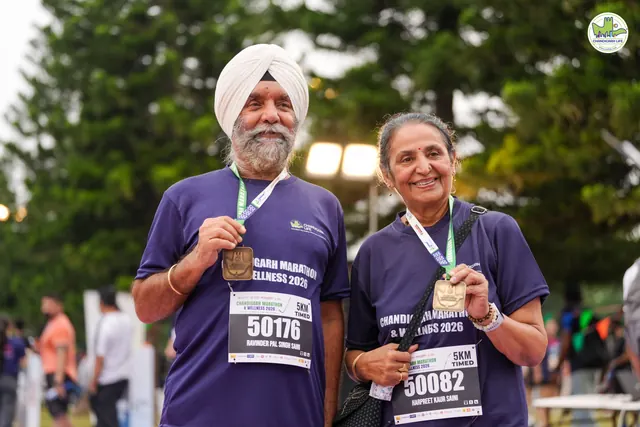 An elderly couple with their finisher medals