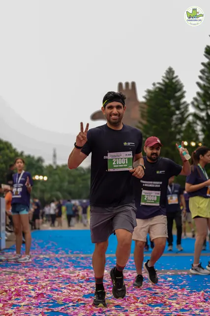 A man flashing a peace sign as he finishes