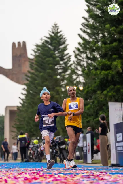 A man in yellow and a boy finishing together
