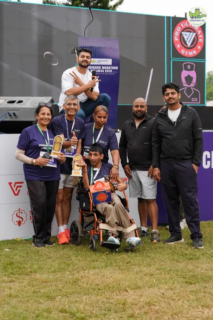 A family with trophies in front of the stage