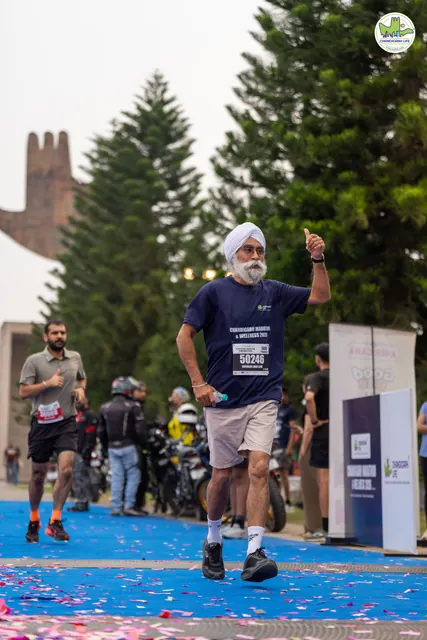 A man with an arm raised at the finish