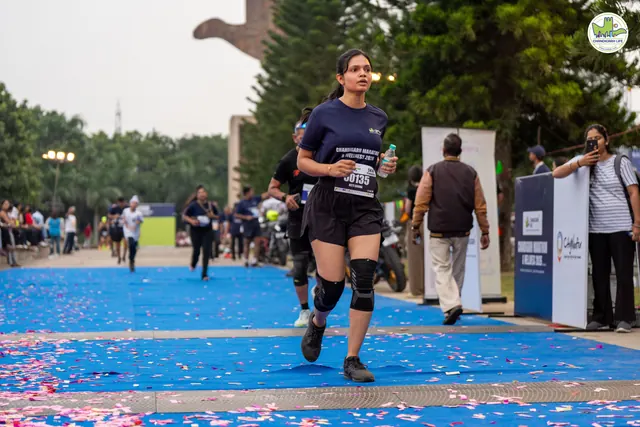 A woman finishing on the blue carpet