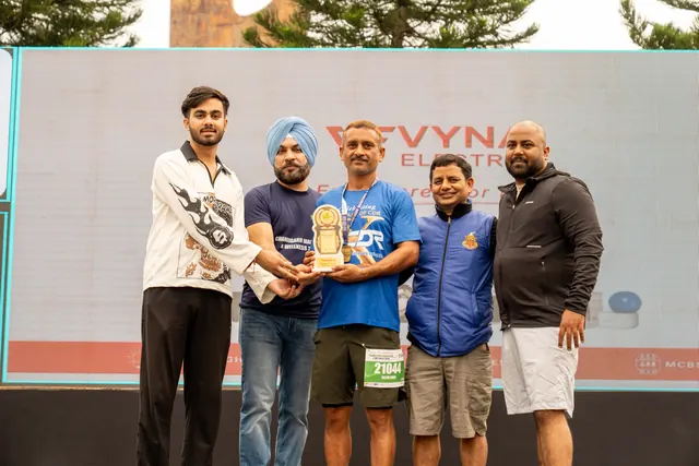 A trophy being handed over on the stage