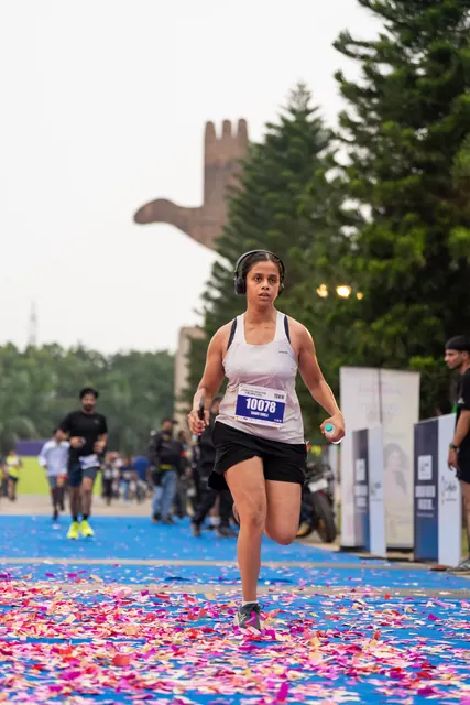 A woman finishing on the blue carpet