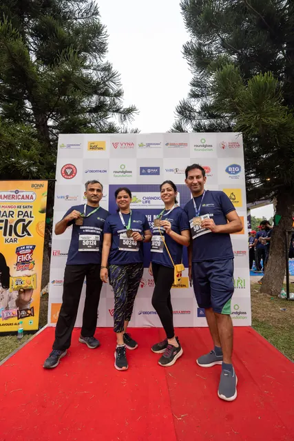 Three participants with certificates on the red carpet