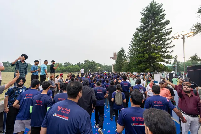 Participants walking towards the stage, seen from behind