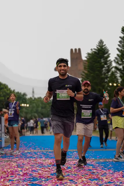 A man finishing on the petal-covered carpet