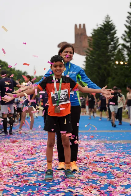 A boy finishing as petals fall