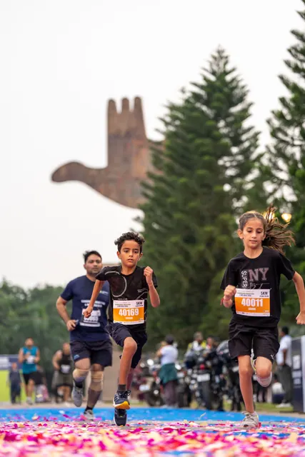 Two children running to the finish