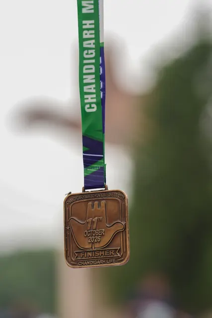 The 2026 finisher medal on its green ribbon