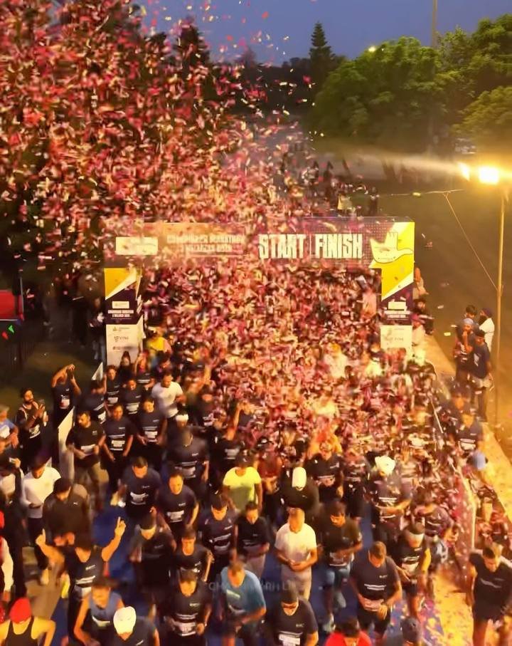 Confetti over a packed start line at the Capitol Complex before dawn on 11 October 2026
